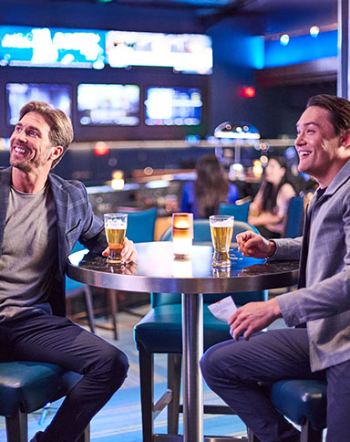 two guys watching the game at a sports book